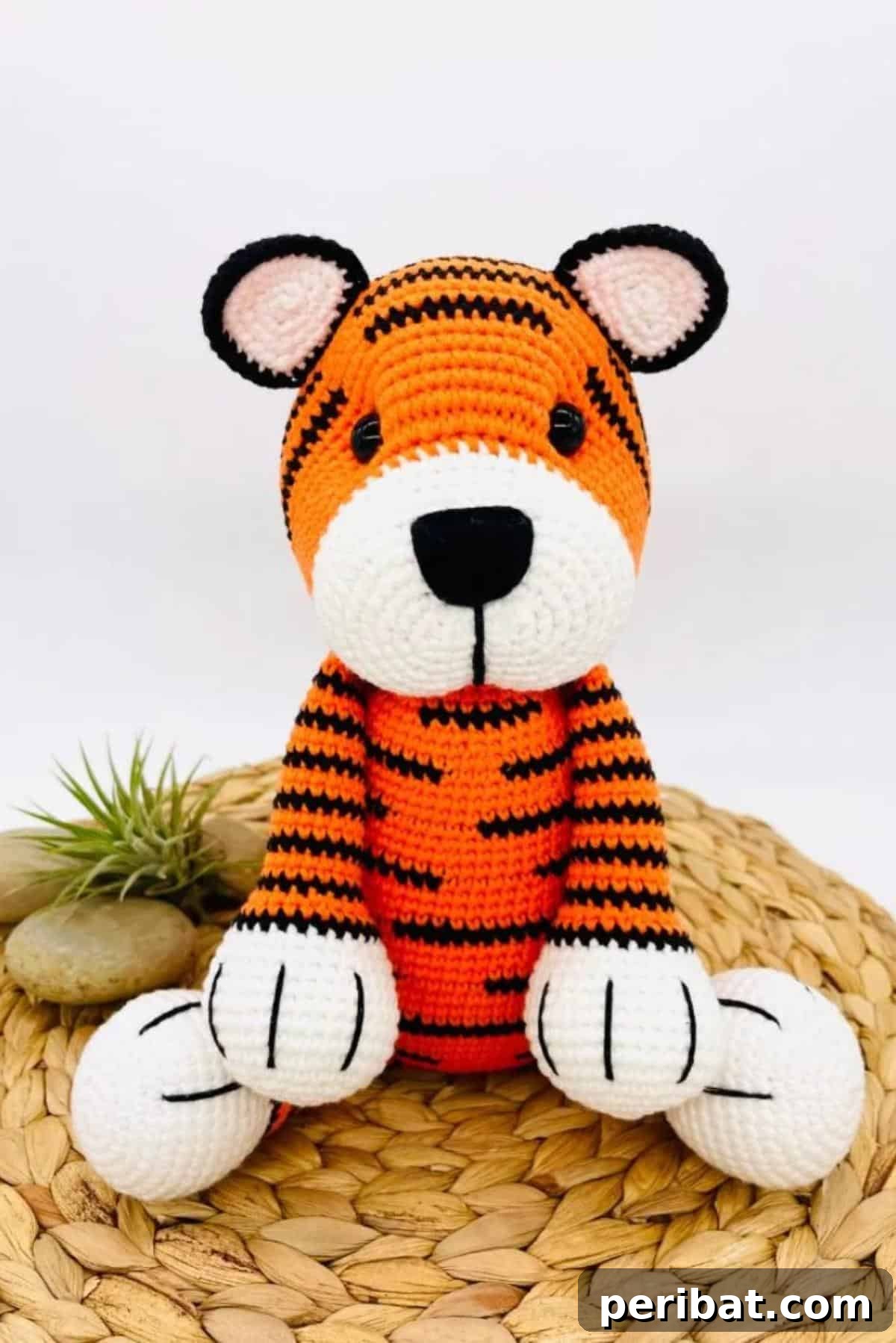 A majestic and playful amigurumi crochet tiger toy with classic orange and black stripes.