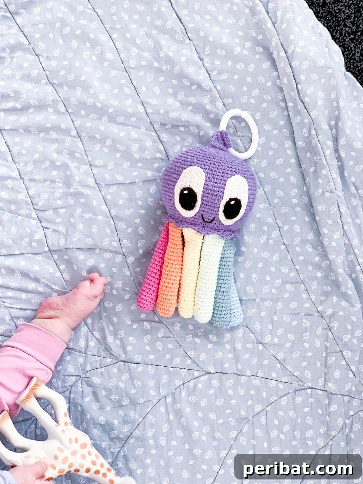 Nora, a cute amigurumi crochet octopus baby toy in a soft pastel color.
