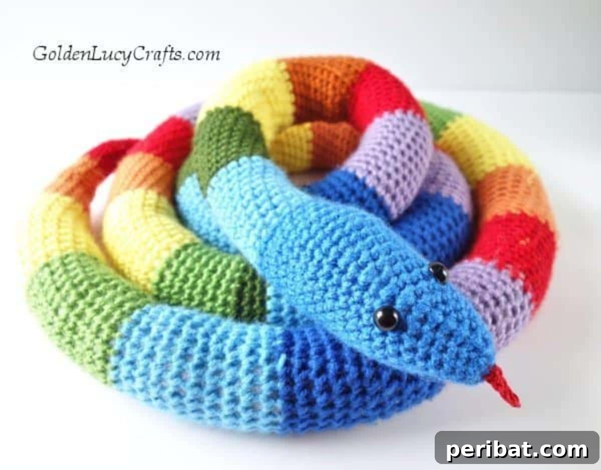 A colorful and playful Crochet Rainbow Snake coiled up.