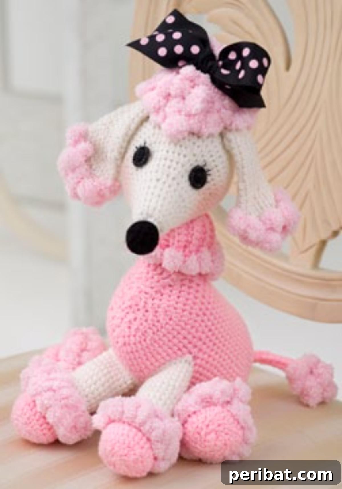 A stylish Pomp Poodle in Pink crochet toy with fluffy features.