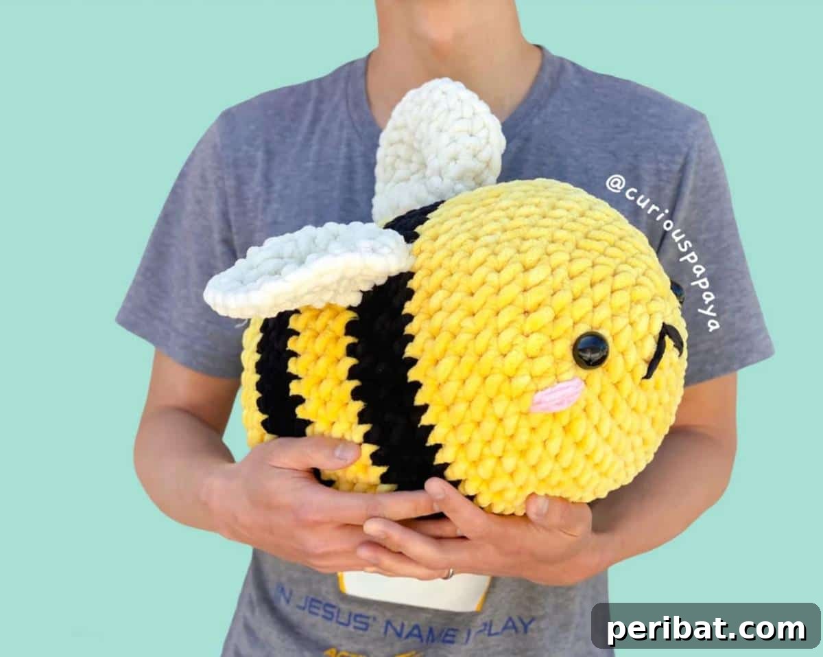 A large, huggable amigurumi Crochet Giant Bee with soft chenille yarn.