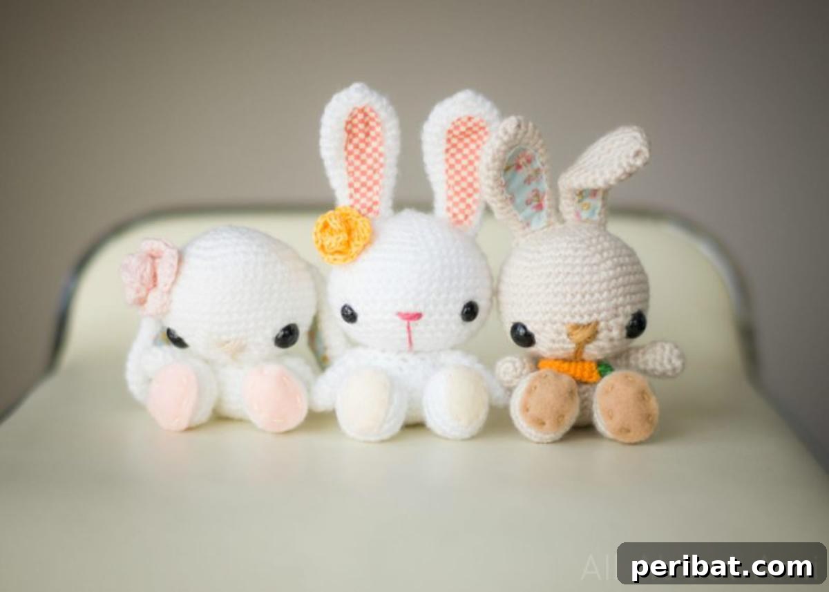 Three adorable knitted spring bunnies with pom-pom tails, perfect for Easter decor.