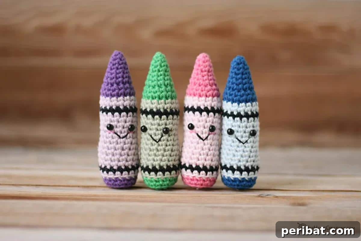33 Cuddly Amigurumi Friends to Crochet 12 A vibrant assortment of crochet Kawaii crayons in various colors, each with a cute smiling face.