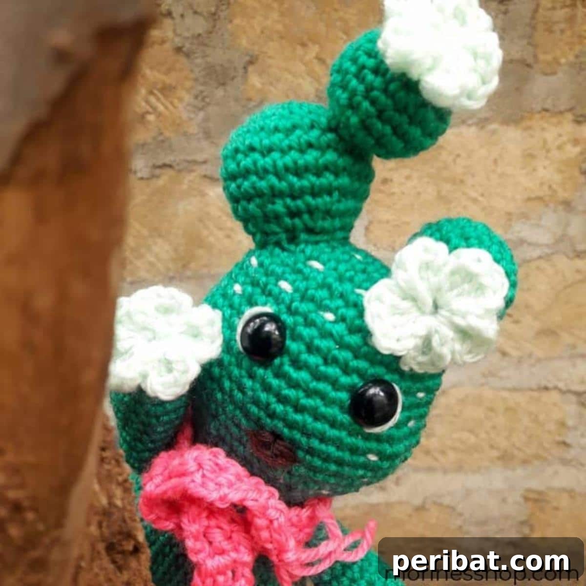 33 Cuddly Amigurumi Friends to Crochet 31 Cactivae the Cactus, an adorable crochet cactus in a terracotta pot, with friendly eyes and rosy cheeks.