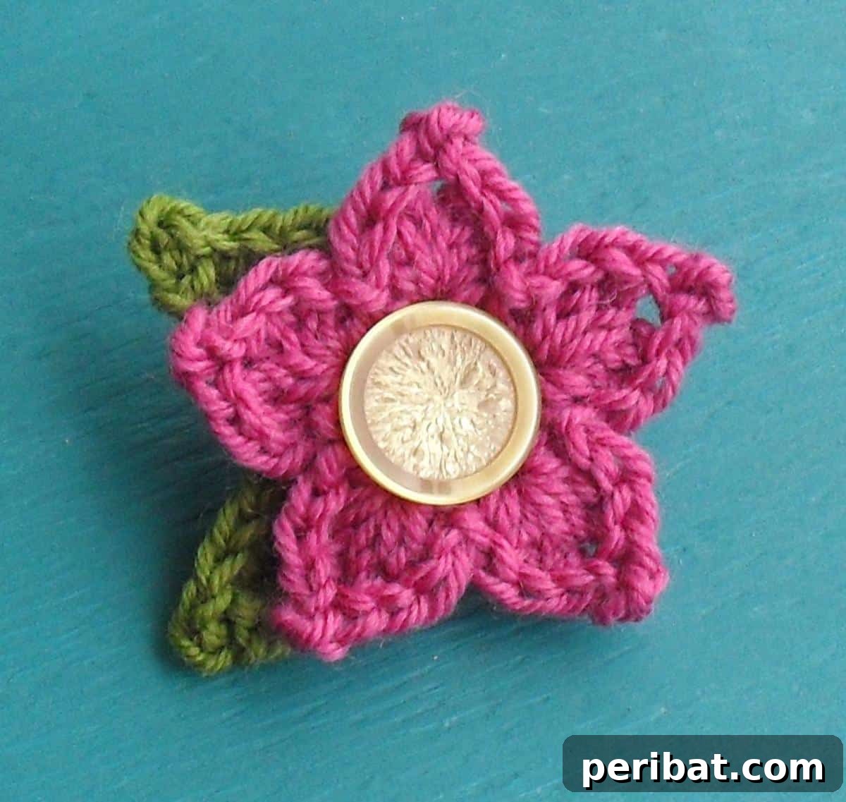 A striking crochet pointy petal flower in a vibrant pink, showcasing unique, angular petals.