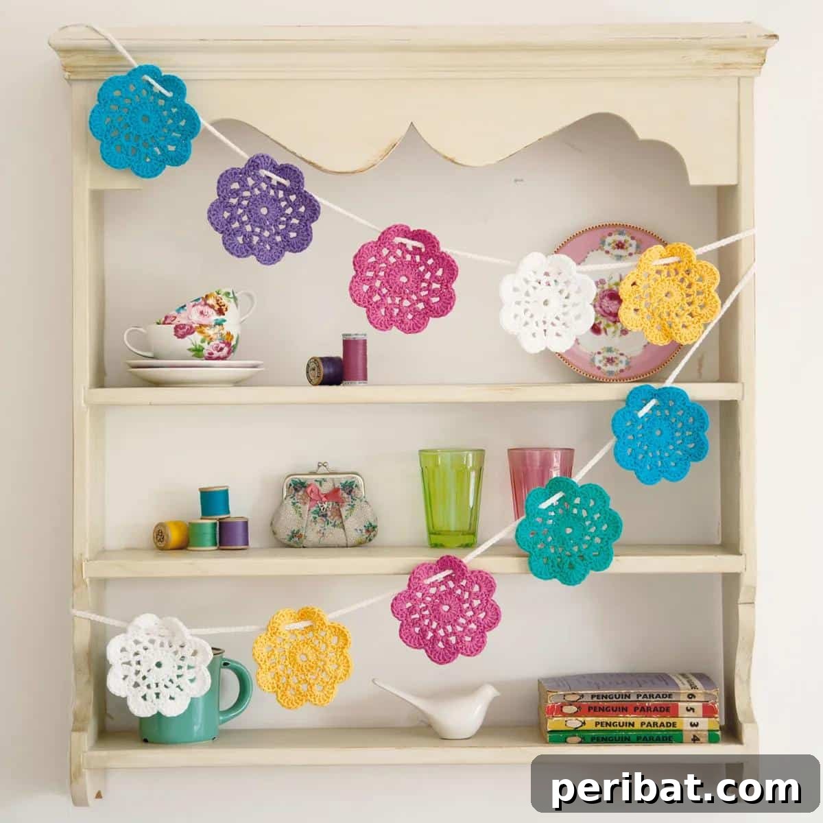 Cheerful crochet flower bunting, strung together to create a festive and colorful decoration.