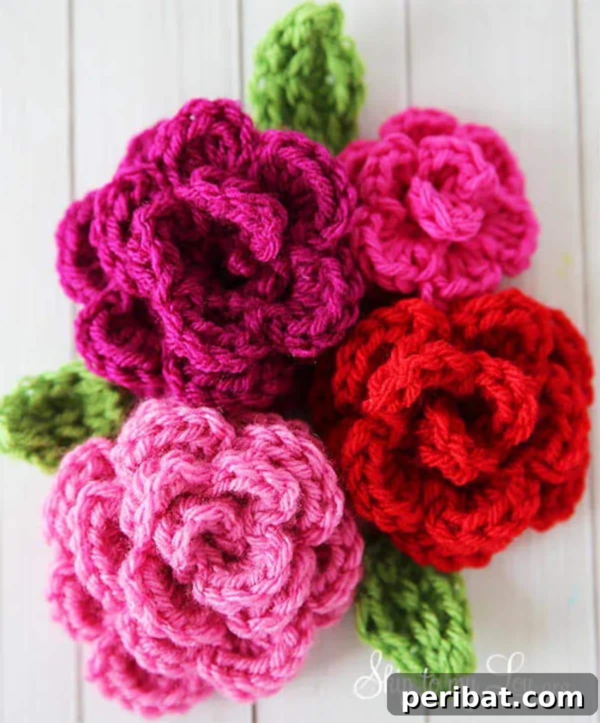Beautiful, easy-to-crochet roses in soft pink and white hues, showcasing a simple yet elegant design.