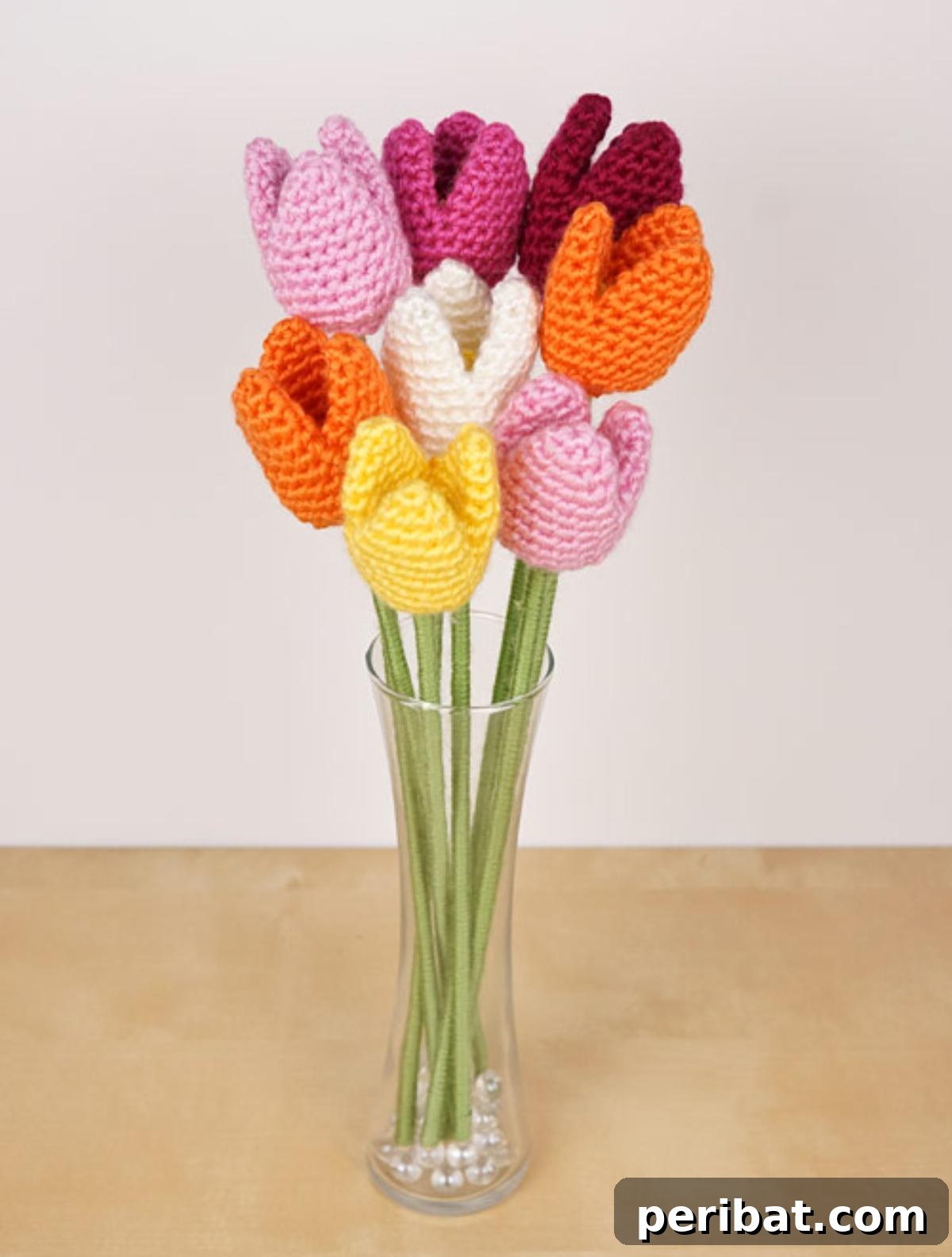 A cheerful cluster of colorful crochet tulips, showcasing their distinct cup-shaped petals.