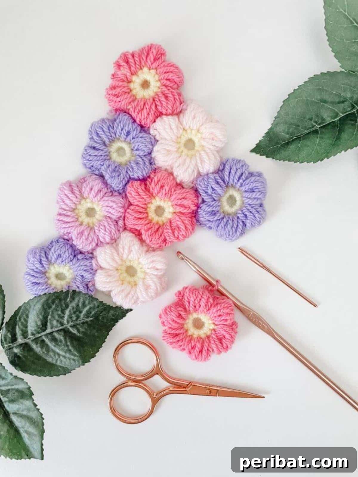 Textured crochet puff flowers in purple and blue, showcasing their unique 3D dimension.