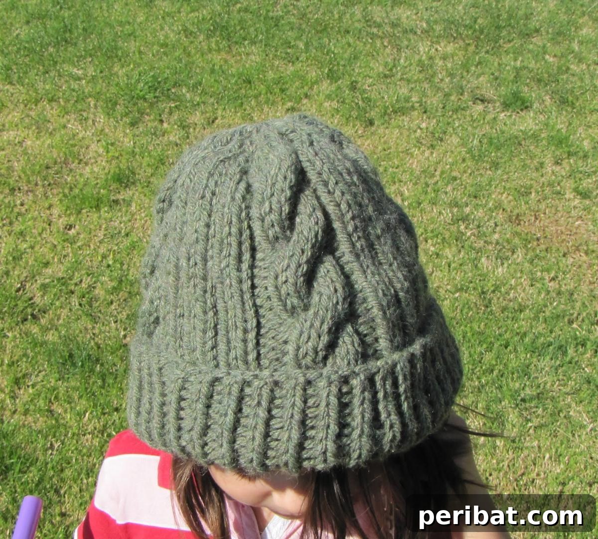 Cozy Knits: 40 Free Beanie Patterns and Tutorials 19 An adorable Custom Cable Hat pattern designed with prominent cables, allowing for extensive personalization through yarn and needle size choices.