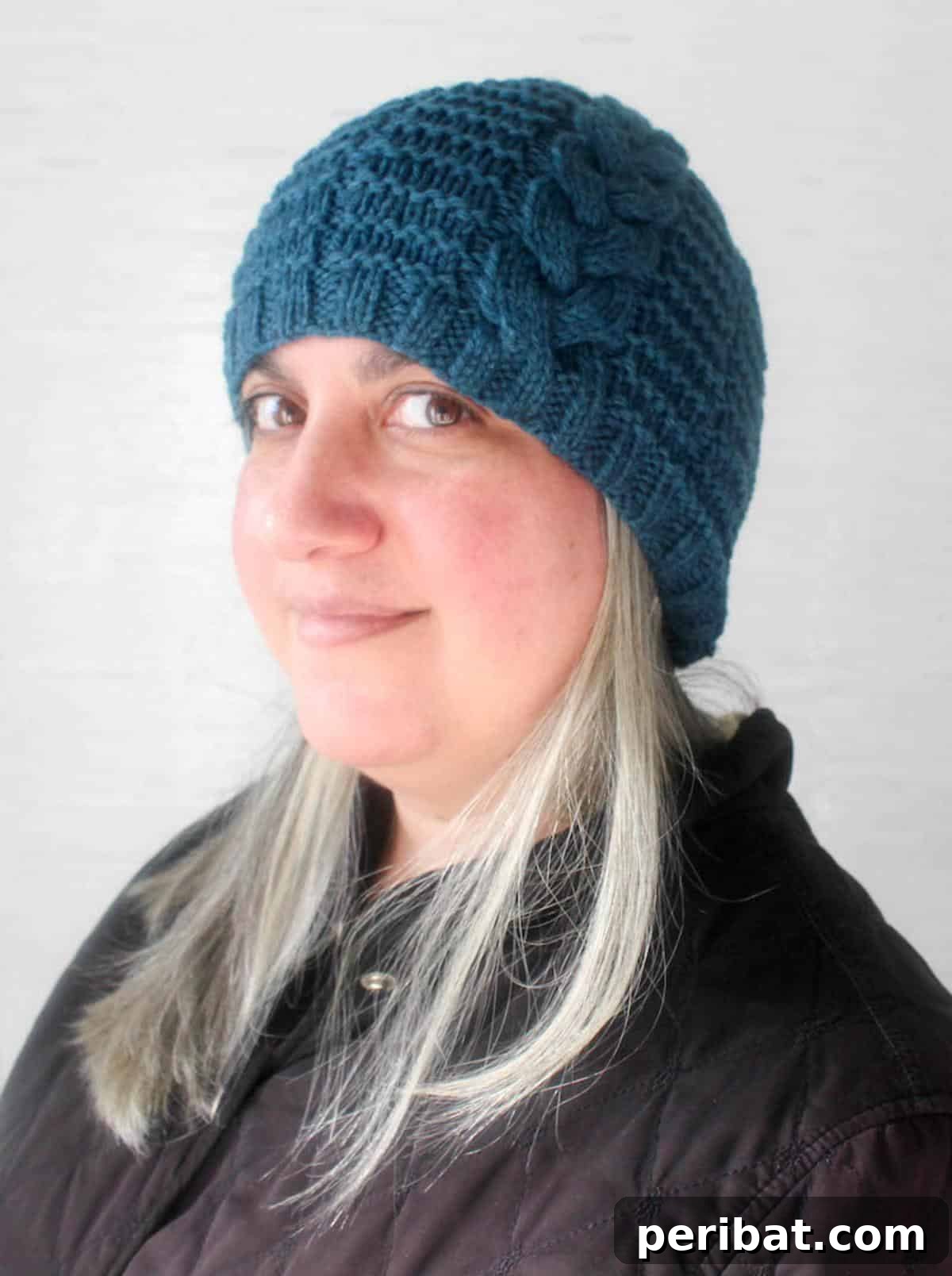 Cozy Knits: 40 Free Beanie Patterns and Tutorials 25 A trendy Braided Beanie pattern, showcasing prominent braided cables in a stretchy, unisex design, perfect for those who love intricate cable work.