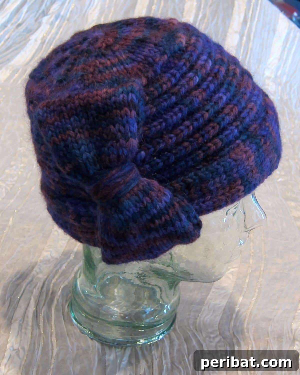 Cozy Knits: 40 Free Beanie Patterns and Tutorials 35 The distinctive Edward Hopper Inspired Portrait Cloche Hat, featuring a thick sculptural bow that covers one ear, providing both warmth and artistic flair.