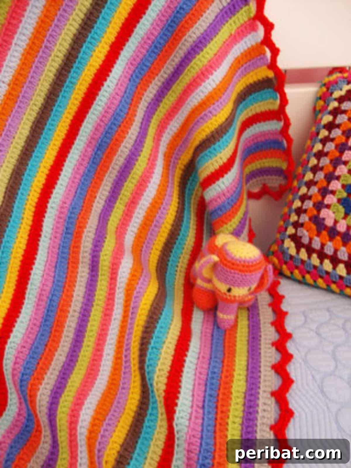 38 Creative Crochet Edging Ideas 8 Cohesive Edging for a Stripy Baby Blanket, tying colors together.