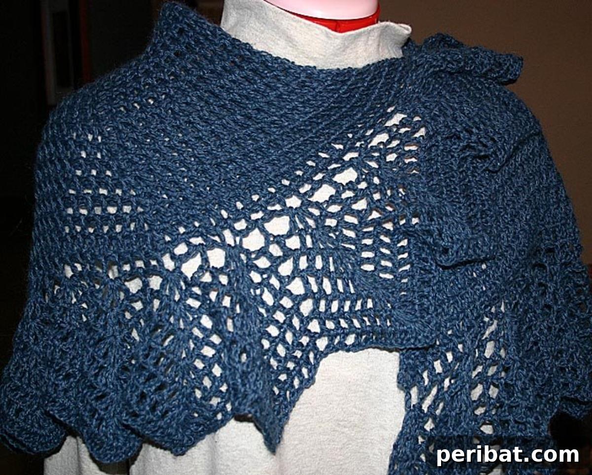 Heirloom Crochet: 40 Timeless Patterns 19 Elegant Madeleine’s Vintage Shawl featuring a central motif and delicate crocheted edging, embodying timeless grace and effortless chic.