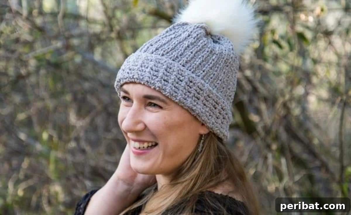 29 Beautiful Tunisian Crochet Projects 9 Easy Tunisian Crochet Hat, showcasing a stylish Tunisian knit-purl texture and a faux fur pom pom.