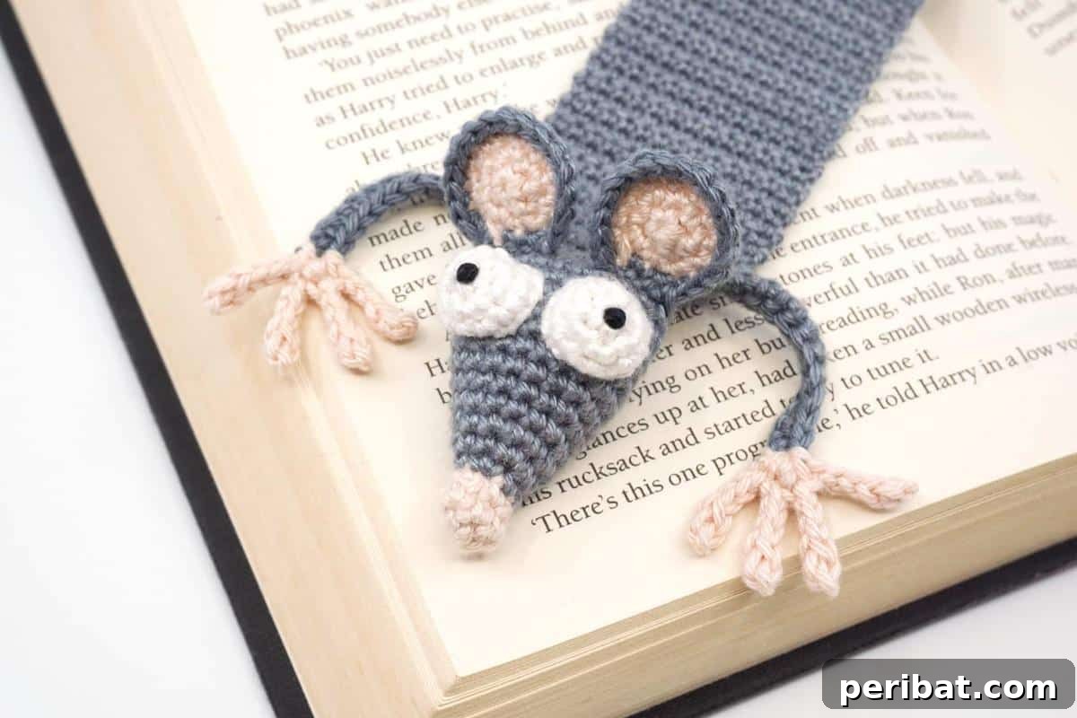 36 Free Crochet Bookmark Designs 16 A cute Amigurumi Crochet Rat Bookmark peeking out from the pages of a book.