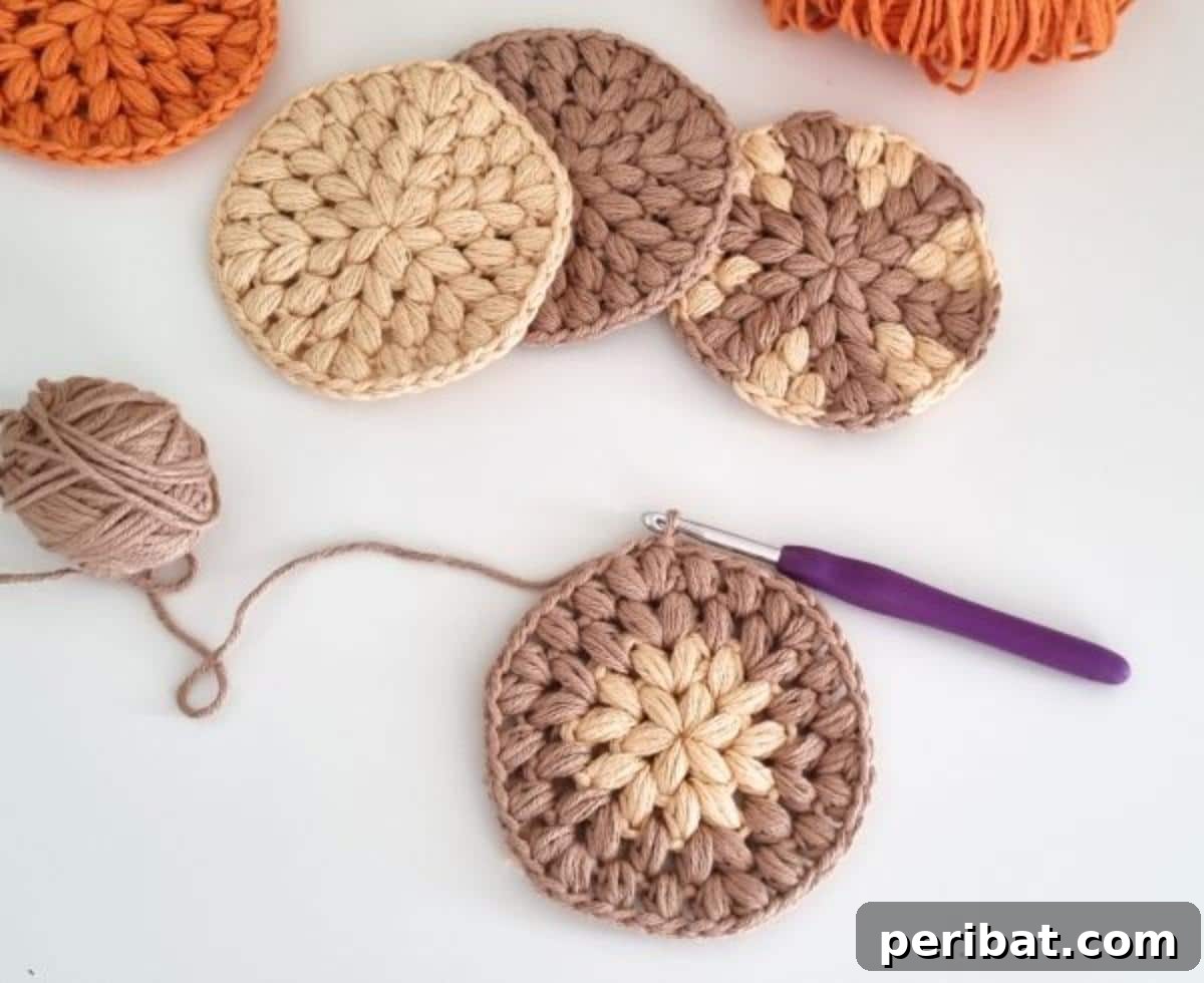 34 Inspiring Crochet Coaster Patterns 25 A simple yet elegant stack of crochet round coasters in muted colors, showcasing versatility and ease of creation.