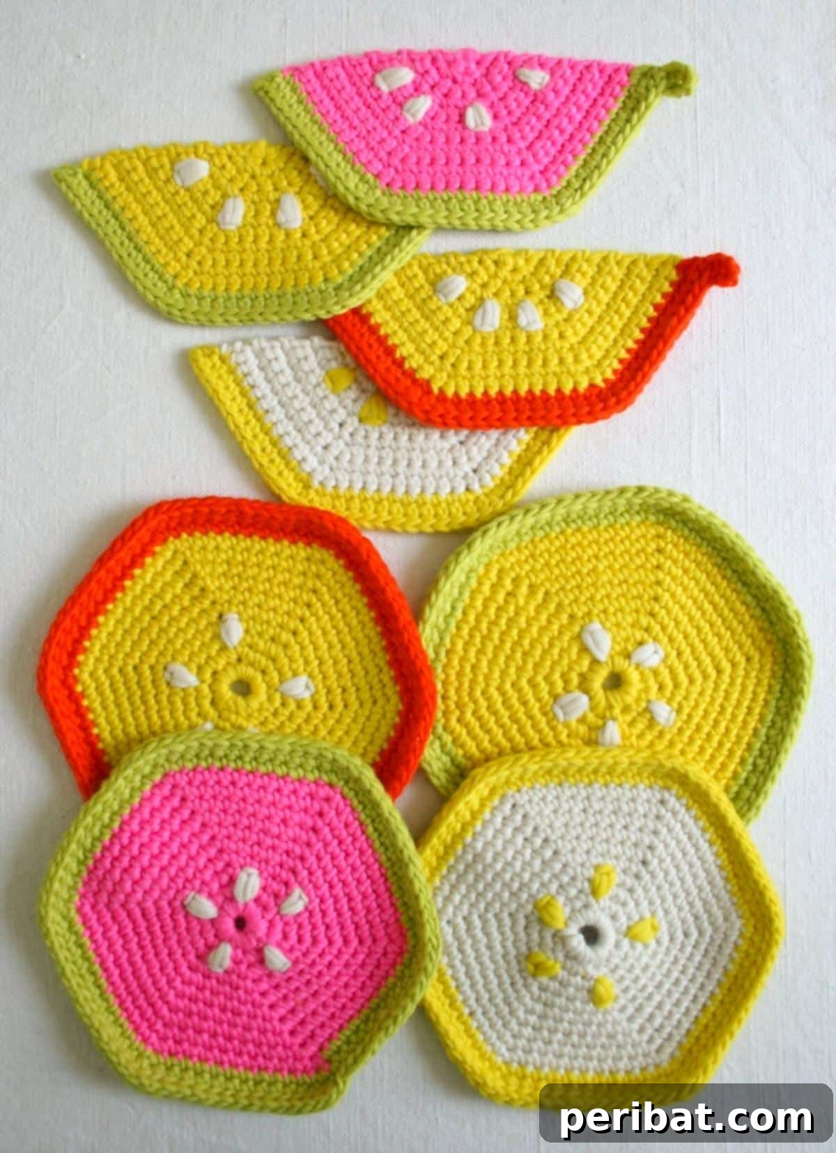 A delightful collection of fruity trivets and pot holders made from super soft merino yarn, shaped like citrus slices in vibrant colors.