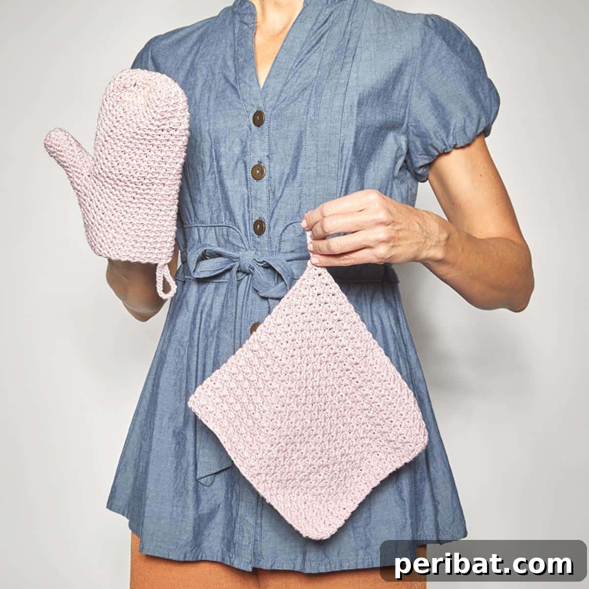 A chic oven mitt crochet set, featuring a matching pot holder, all crafted with a distinctive textured lemon stitch for added grip and style.