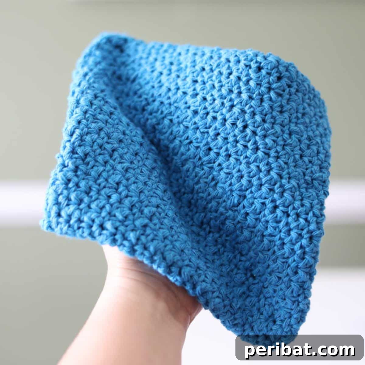 A vibrant Magic Lemon Peel Potholder, showcasing the unique and appealing textured Suzette stitch in a bright, cheerful color.