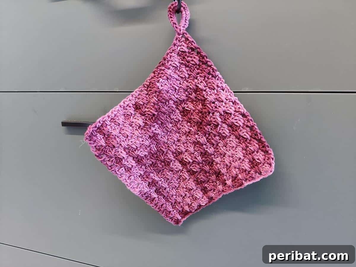 A unique tree branch crochet hot pad, featuring an organic, raised texture that elegantly mimics natural wood or bark.