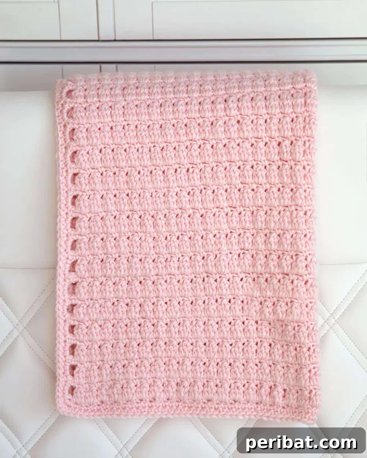 26 Quick & Cozy Chunky Crochet Projects 14 A soft and textured Cluster Stitch Crochet Baby Blanket, showcasing its intricate yet comforting pattern.
