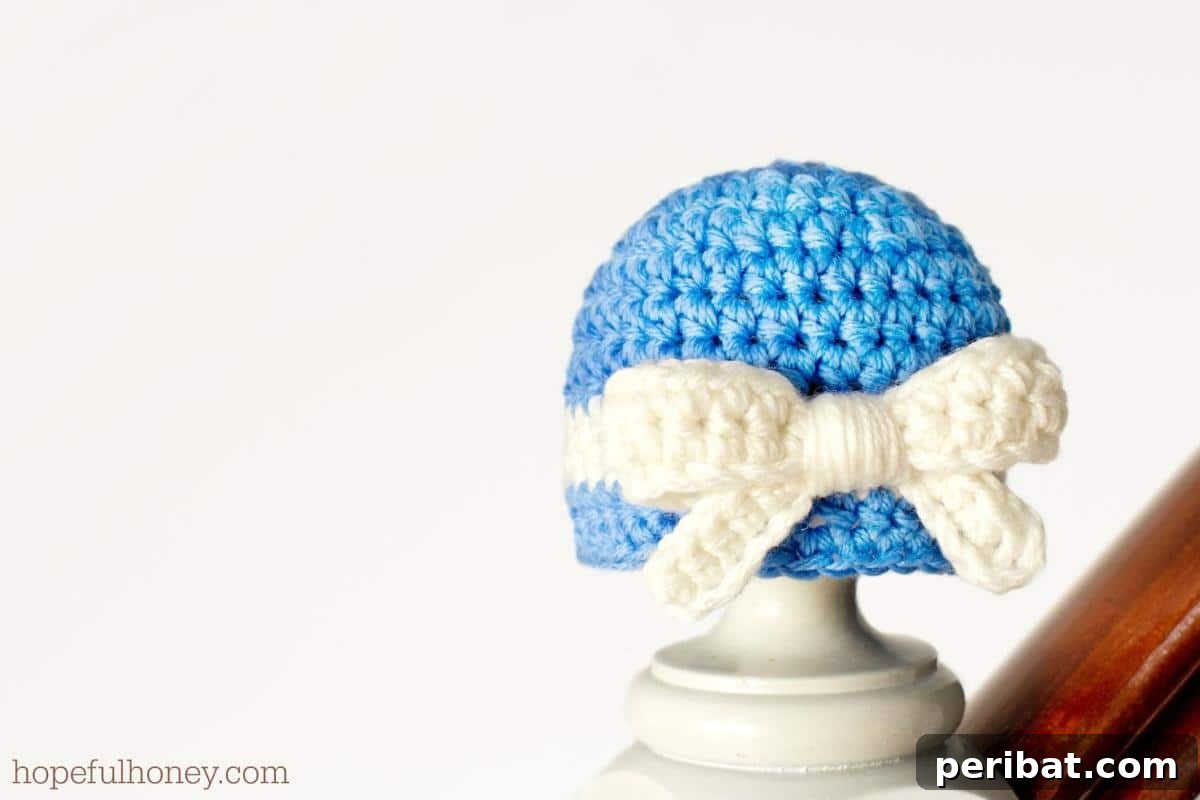 26 Quick & Cozy Chunky Crochet Projects 17 An adorable Darling Newborn Hat and Bow set, perfectly sized for infants and featuring a delicate design.