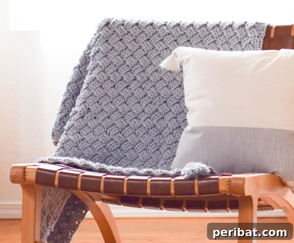 26 Quick & Cozy Chunky Crochet Projects 3 A close-up view of a Diagonal Diamonds Woven Crochet Throw, showcasing its intricate yet cozy basket weave stitch pattern.