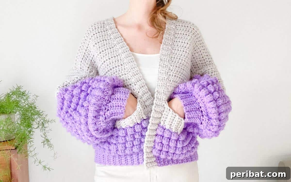 26 Quick & Cozy Chunky Crochet Projects 25 A fashionable Crochet Bobble Stitch Cardigan, showcasing its unique textured bobbles and oversized, comfortable fit.
