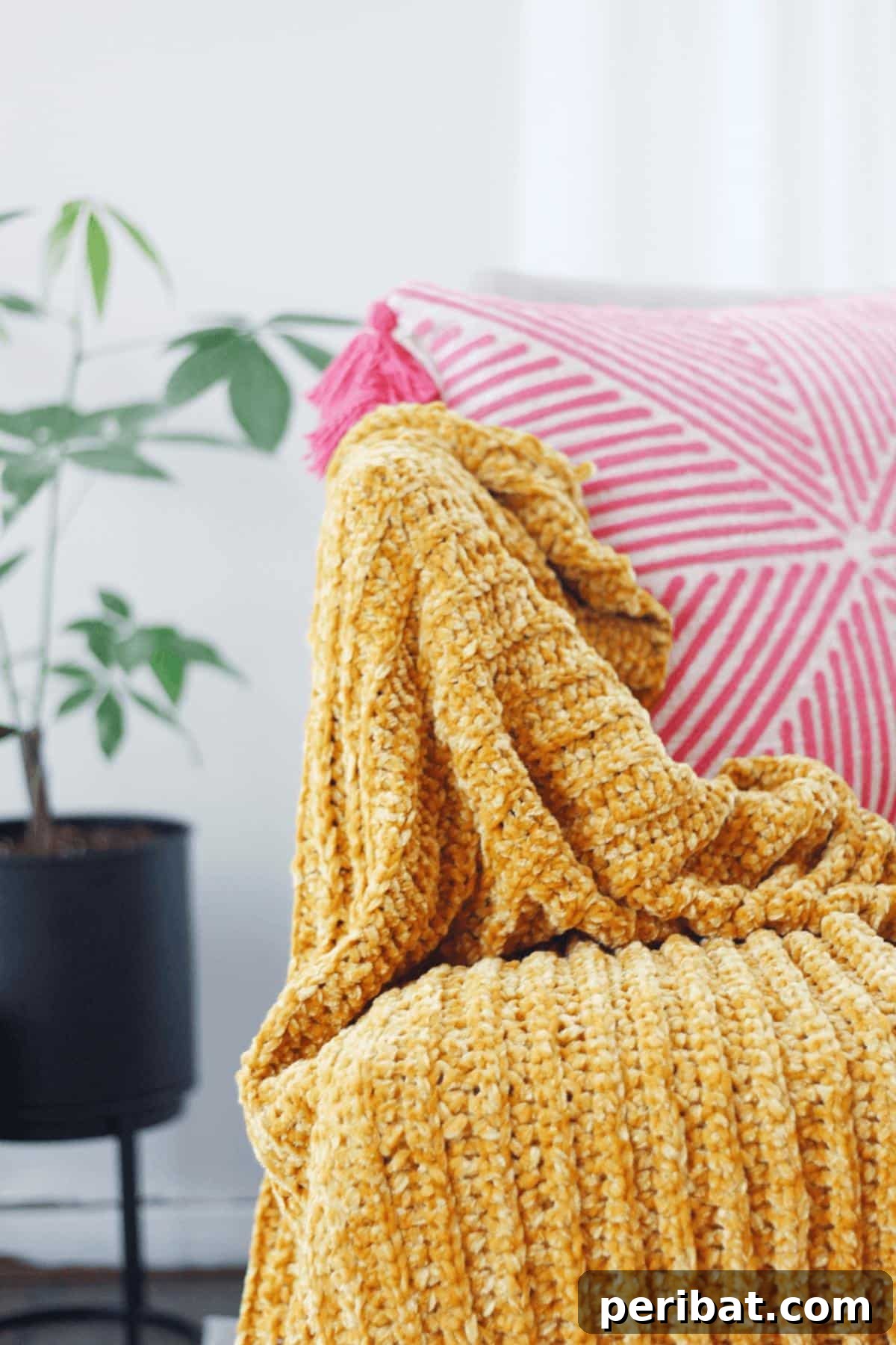 26 Quick & Cozy Chunky Crochet Projects 4 A luxuriously soft Chunky Velvet Crochet Blanket draped elegantly, highlighting its plush texture and deep color.