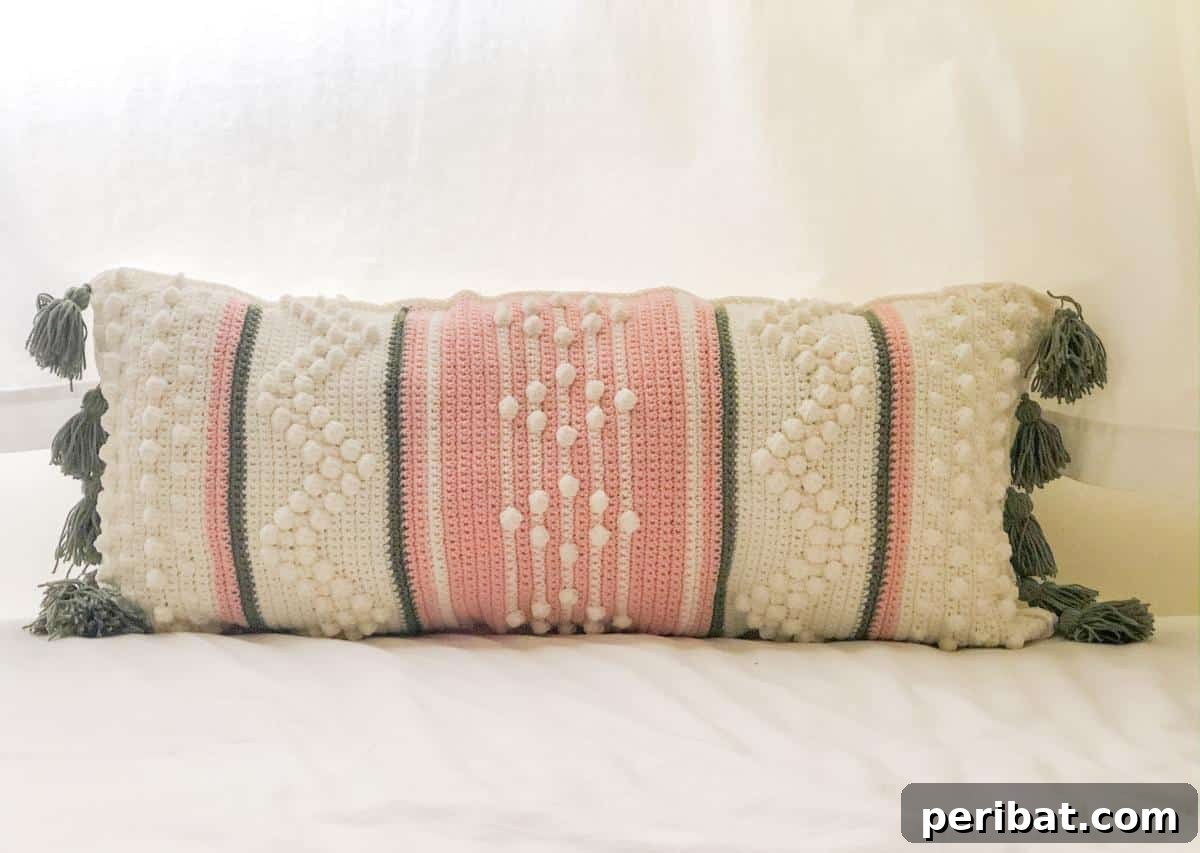 40 Creative Crochet Pillow Projects 13 An Anthropologie-inspired long crochet pillow, featuring elegant textured stitches and a sophisticated, bohemian aesthetic.