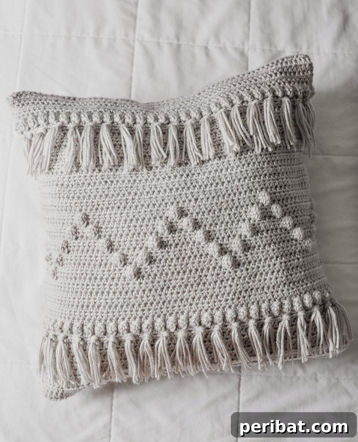 40 Creative Crochet Pillow Projects 17 A stylish funky fringe pillow, crafted with simple crochet and bobble stitches, featuring a long, playful fringe detail.
