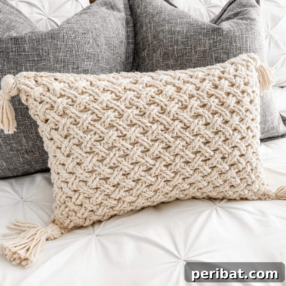 40 Creative Crochet Pillow Projects 24 An intricate Celtic Weave crochet throw pillow, showcasing a rich, textured cable pattern that adds a sophisticated touch.