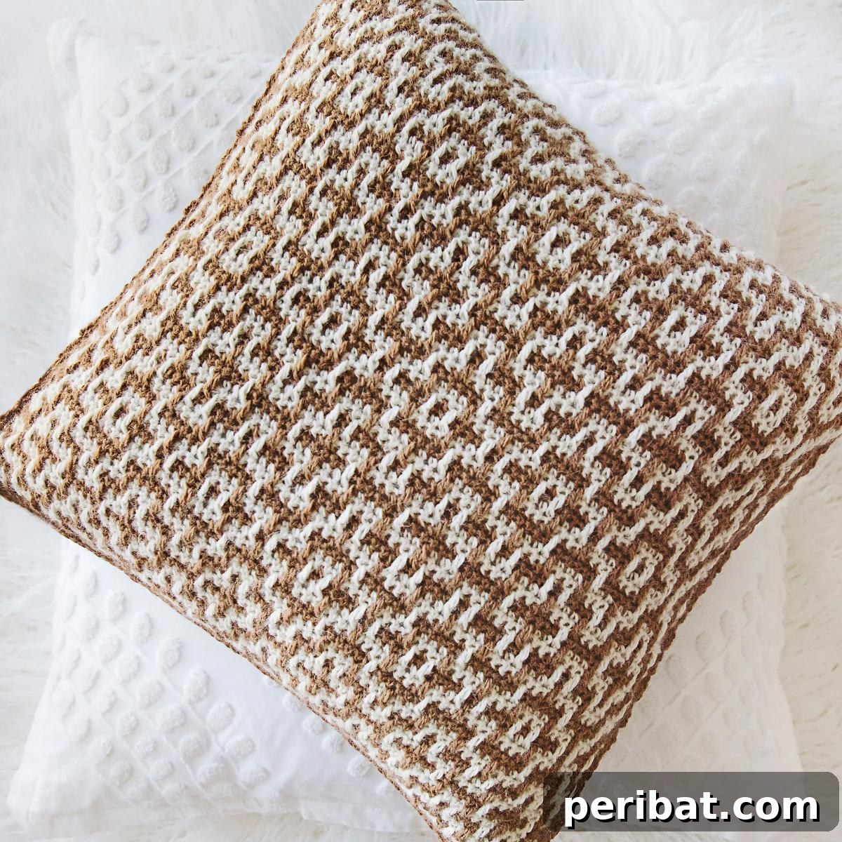 40 Creative Crochet Pillow Projects 26 A modern mosaic crochet throw pillow, featuring an intricate geometric pattern created with contrasting colors, ideal for contemporary decor.