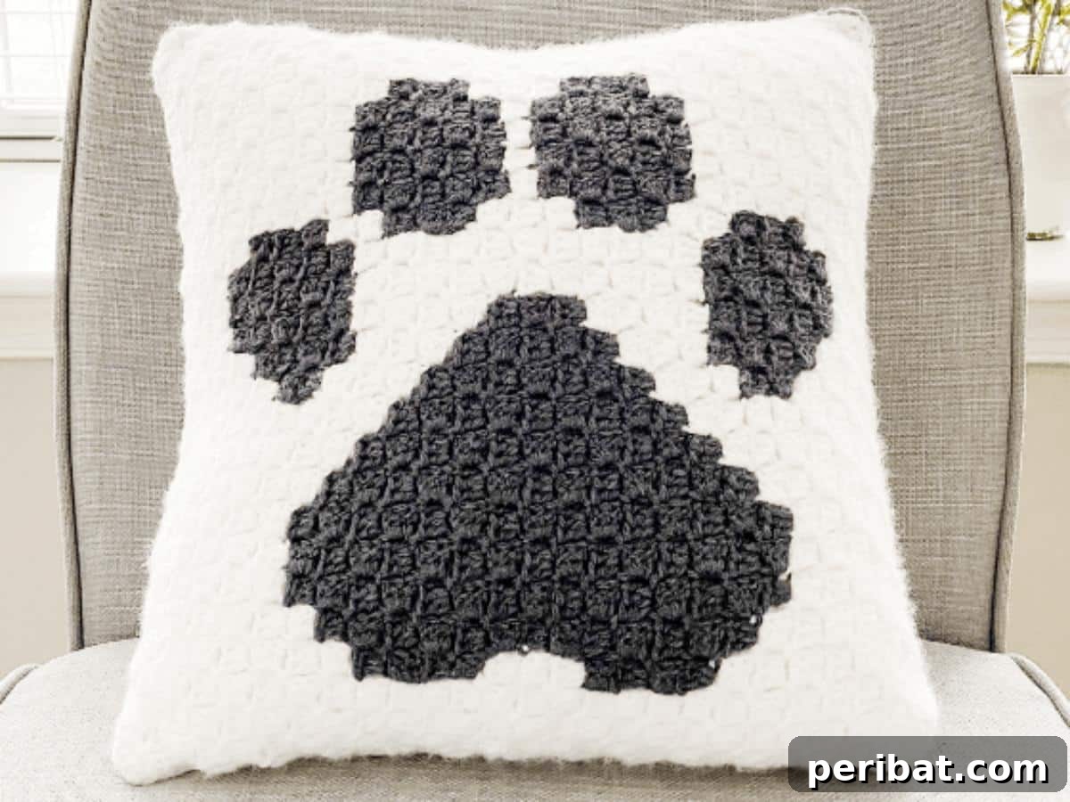 40 Creative Crochet Pillow Projects 33 A heartwarming crochet paw print pillow, featuring an adorable paw print design, perfect for pet lovers to show affection for their furry friends.