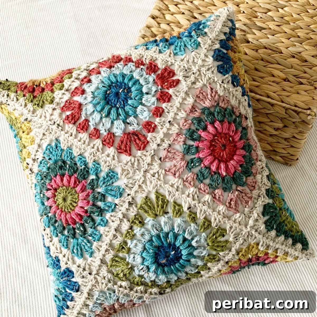 40 Creative Crochet Pillow Projects 7 A cozy Hygge Burst Granny Square Pillow, featuring a sunburst-like design within classic granny squares, perfect for a warm home aesthetic.