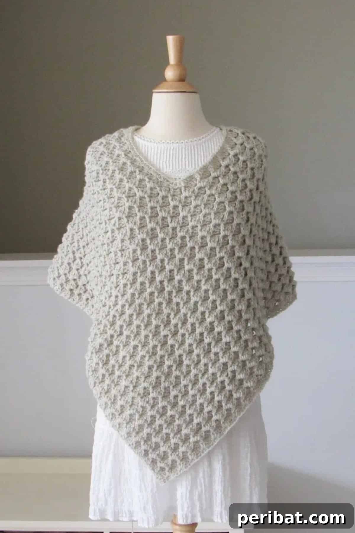 Elegant Lavinia Poncho featuring a chic crochet turtleneck design, perfect for warmth and sophisticated style.