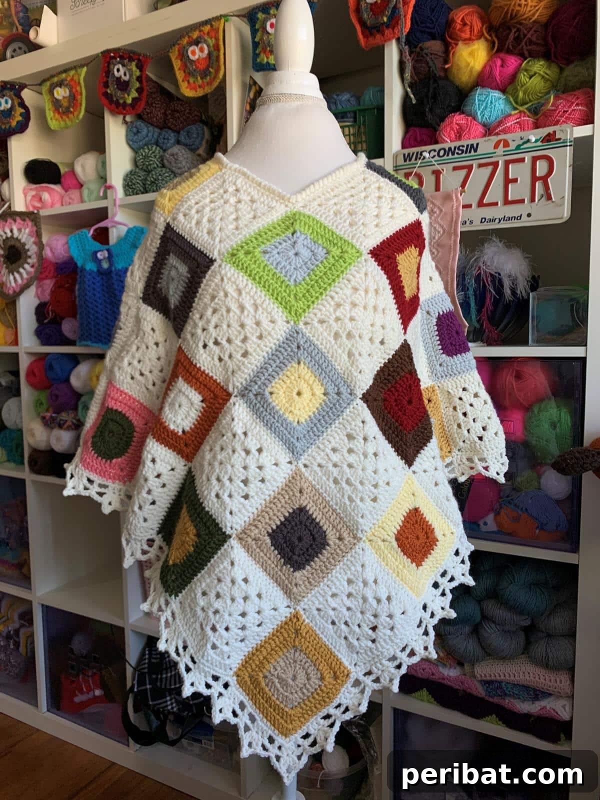 Scrappy Squares Poncho, a fun and colorful crochet pattern ideal for using up leftover yarn scraps.