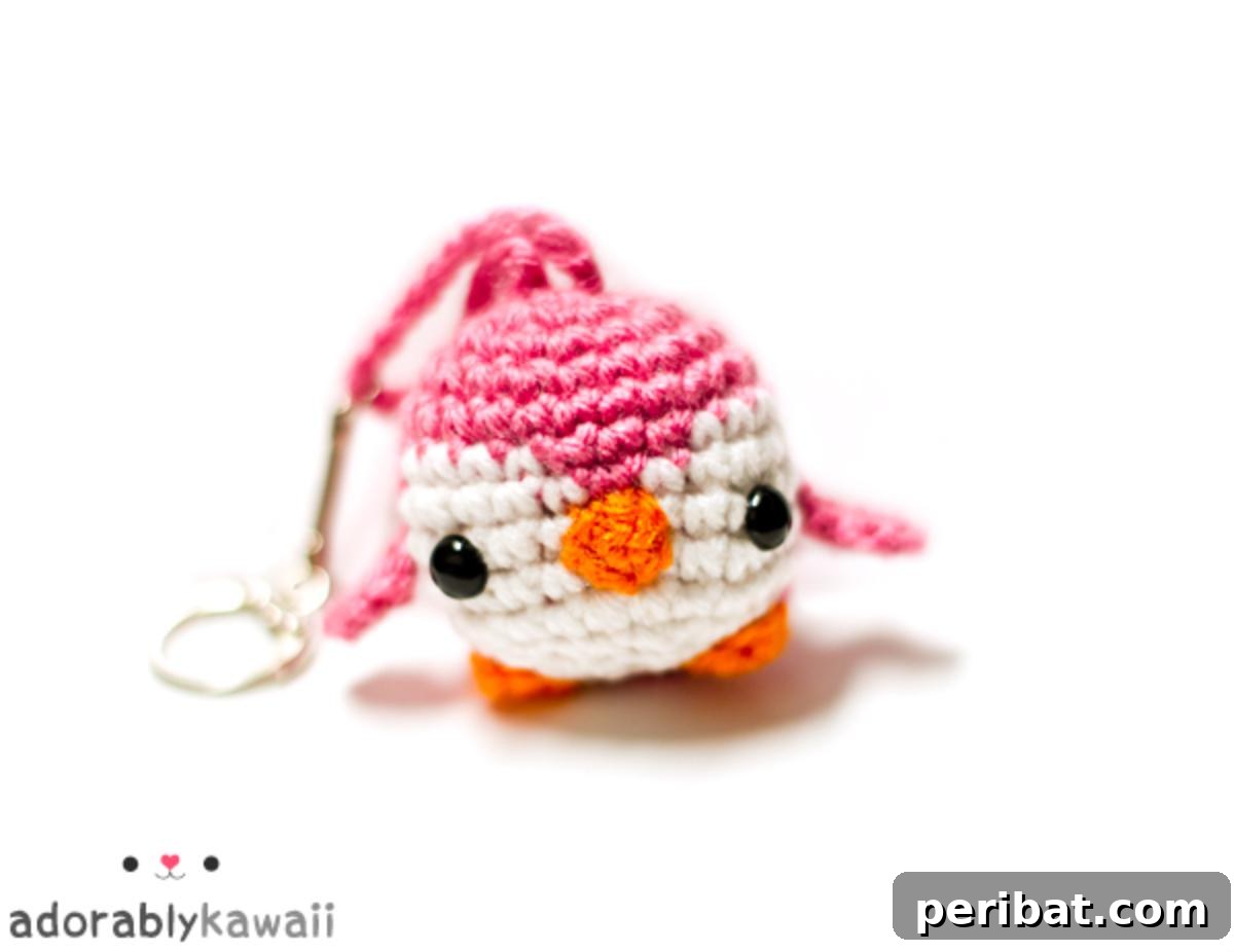 38 Adorable Crochet Keychain Patterns 3 Mini Penguin Amigurumi Keychain with black and white yarn and an orange beak.