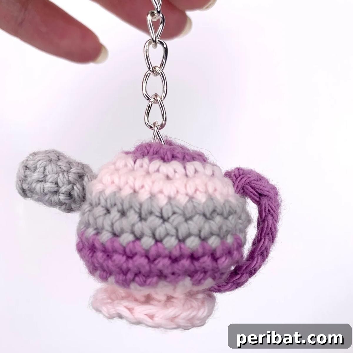 38 Adorable Crochet Keychain Patterns 22 Tiny Tea Pot Crochet Amigurumi Keychain in a soft blue color.