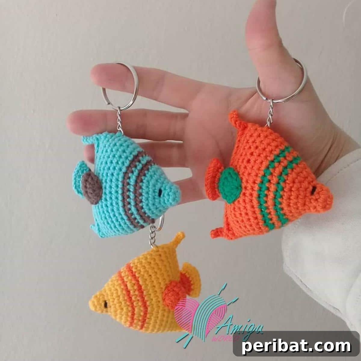 38 Adorable Crochet Keychain Patterns 24 Fish Keychains in various bright colors with small fins.
