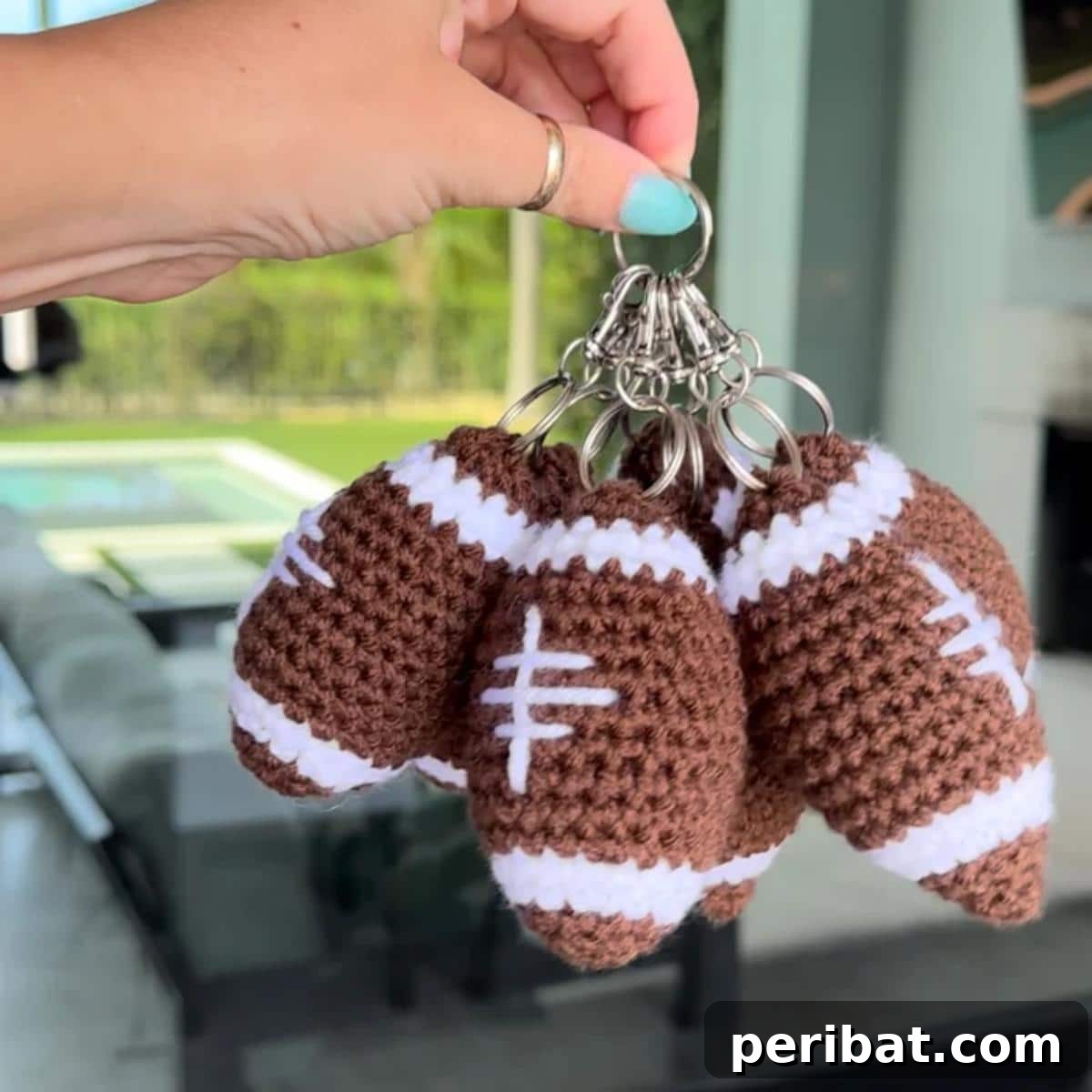 38 Adorable Crochet Keychain Patterns 29 Crochet Football Keychains with brown yarn and white laces.