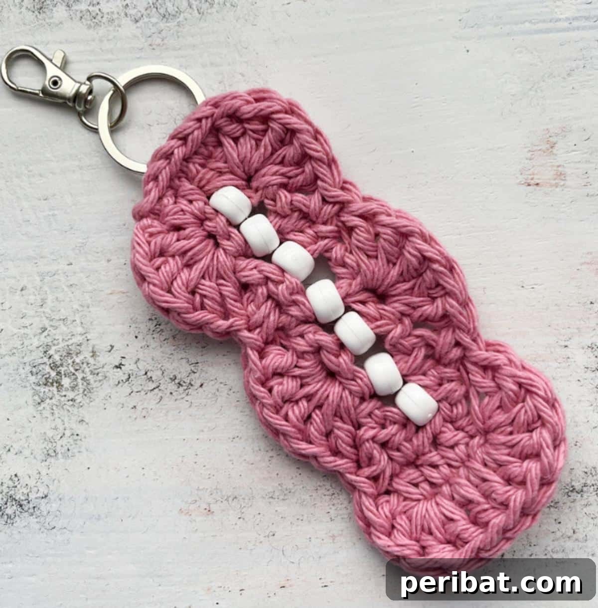 38 Adorable Crochet Keychain Patterns 32 Crochet Fidget Keychain With Beads, showcasing colorful beads woven into a crochet loop.