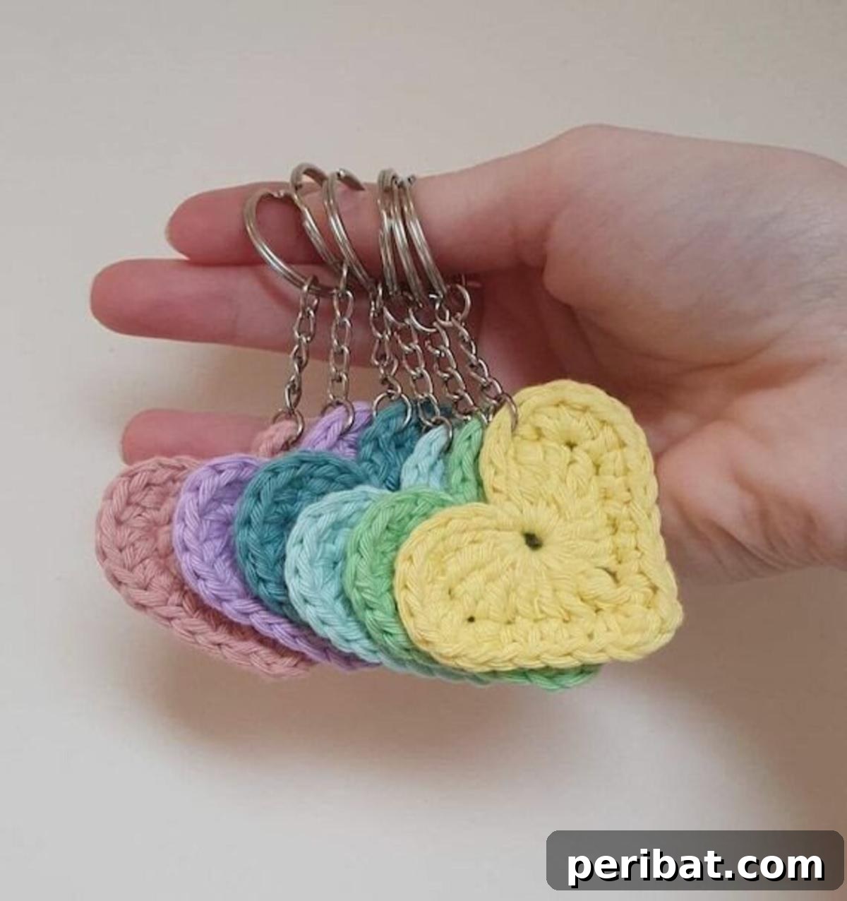 38 Adorable Crochet Keychain Patterns 37 Crochet Heart Keychains in various shades of red and pink.