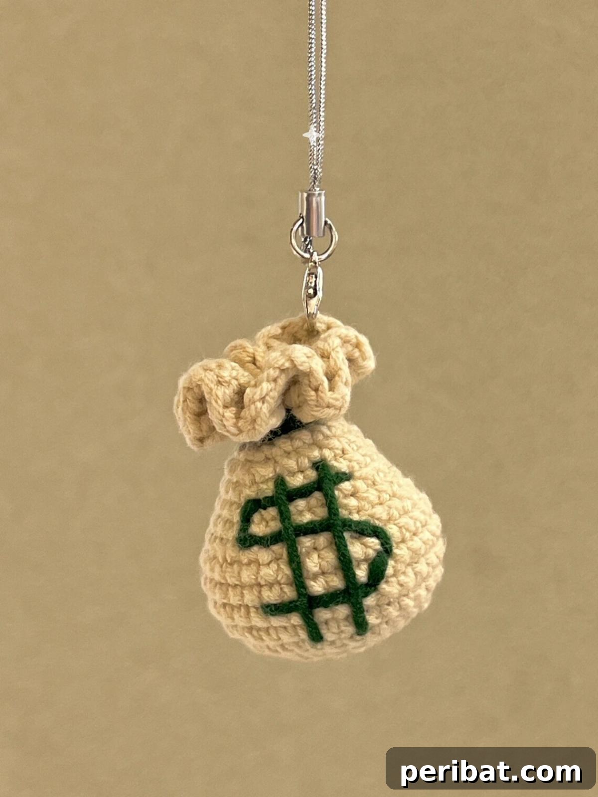 38 Adorable Crochet Keychain Patterns 39 Dollar Sign Money Bag Keychain, a small green bag with a dollar sign.