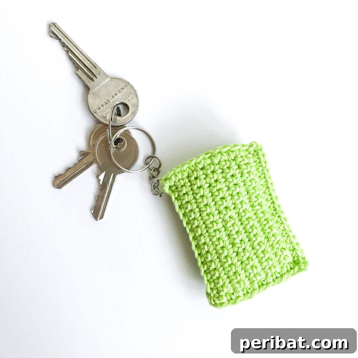 38 Adorable Crochet Keychain Patterns 5 Book Crochet Keychain showing a miniature book with a light brown cover.
