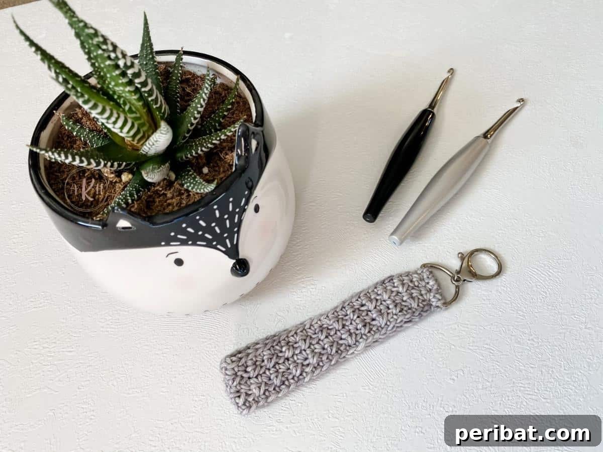 38 Adorable Crochet Keychain Patterns 7 Crossroads Wristlet Strap in a textured white yarn.