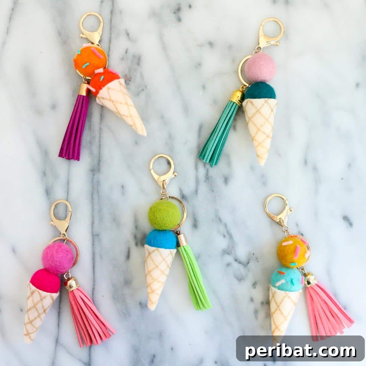22 Creative Ice Cream Cone Projects for Summer Fun 16 A close-up of adorable DIY felt ball ice cream cone keychains, showing soft felt balls representing scoops on tiny crafted cones, complete with key rings for practical use.