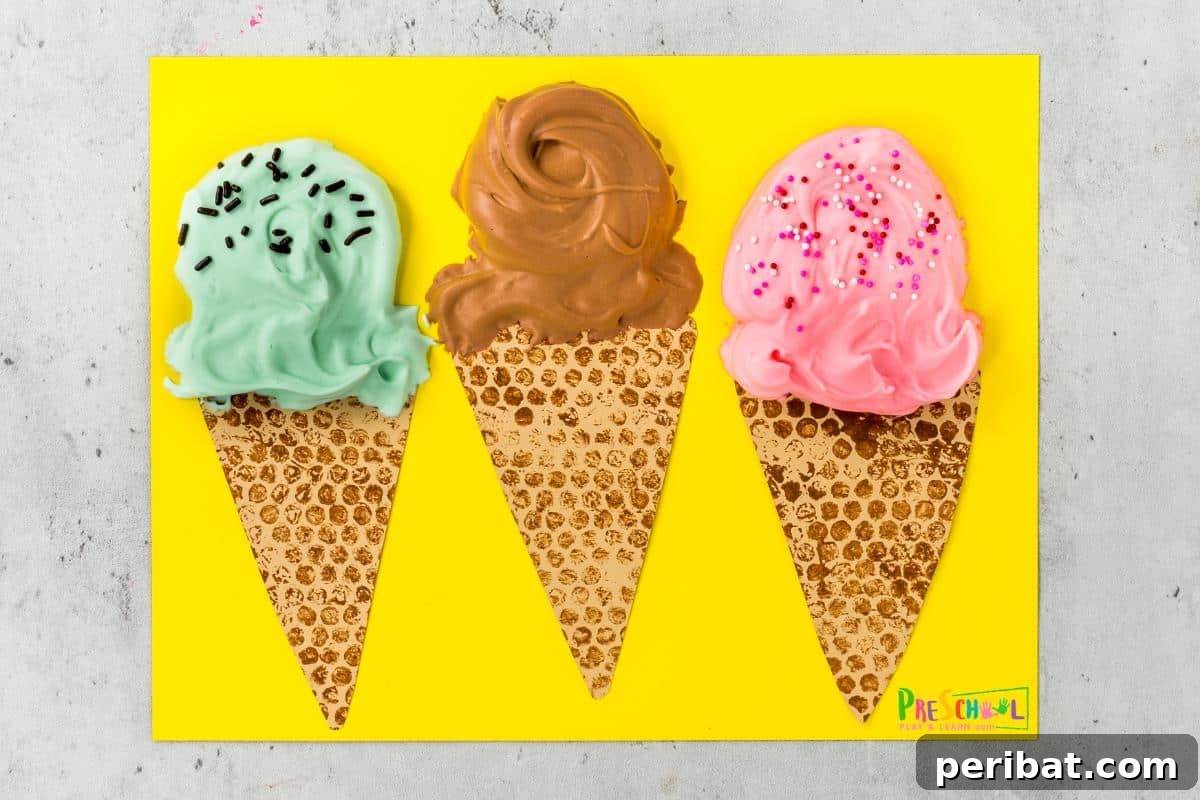 22 Creative Ice Cream Cone Projects for Summer Fun 17 A vibrant bubble wrap and puffy paint summer ice cream craft designed for preschoolers, featuring textured 'scoops' made with bubble wrap printing and puffy paint details on a paper cone, promoting sensory play.