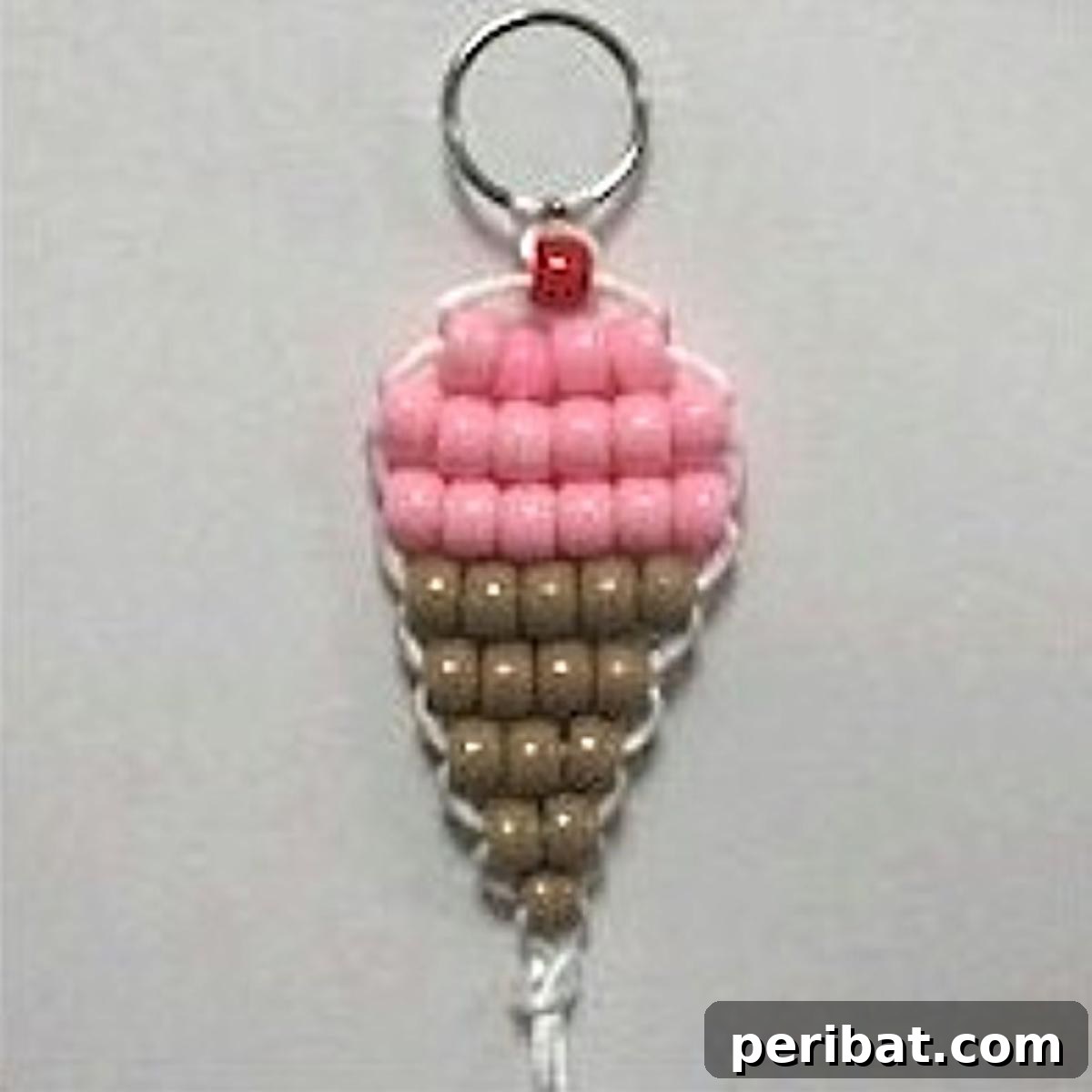 22 Creative Ice Cream Cone Projects for Summer Fun 19 An intricate ice cream cone bead pattern craft, showcasing small colorful beads meticulously arranged to form a detailed ice cream cone, suitable for beading enthusiasts.